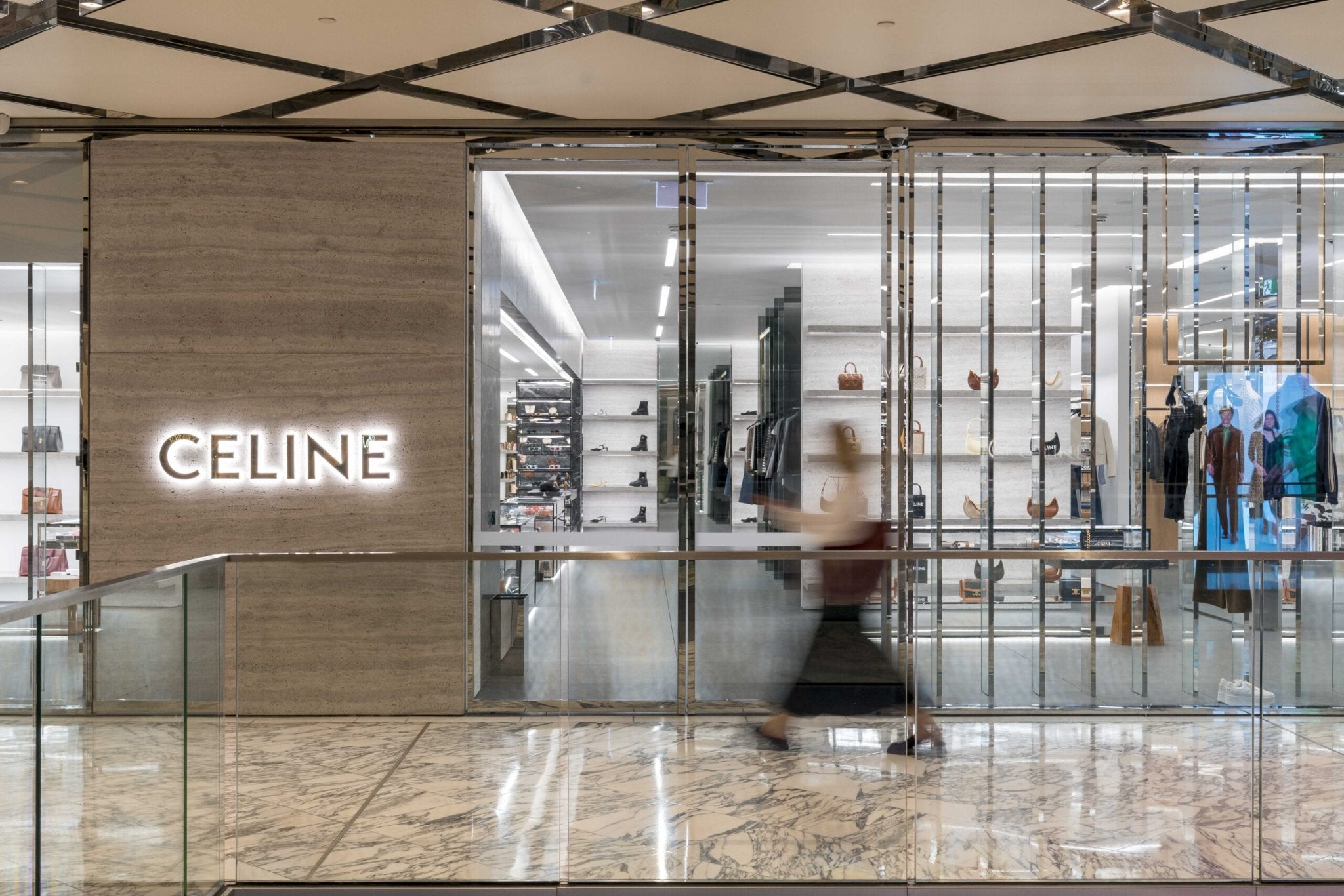 Celine modern store front with big windows displaying new and used vintage bags and accessories in a shopping mall - Forgotten Luxuries