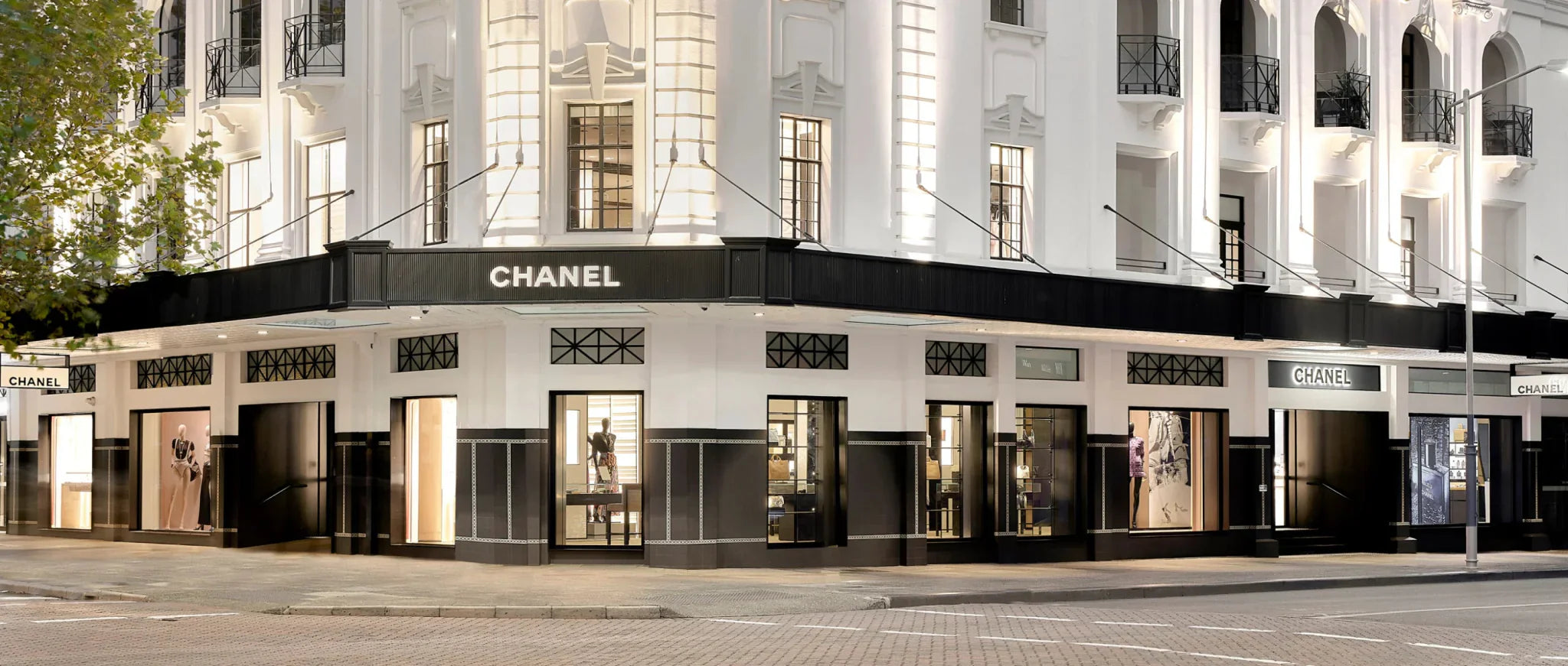 Iconic famous new Chanel store front corner building in white and black selling new and used vintage Chanel bags - Forgotten Luxuries