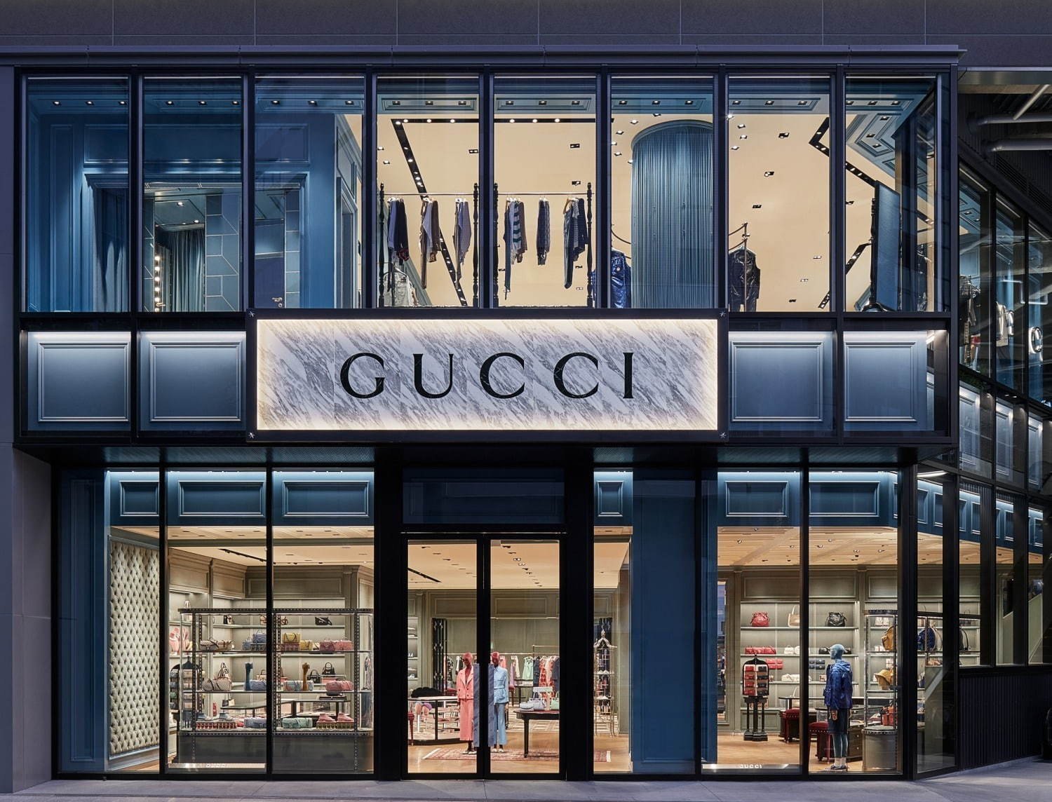 Gucci modern store front with floor to ceiling glass selling new and used vintage gucci bags - Forgotten Luxuries