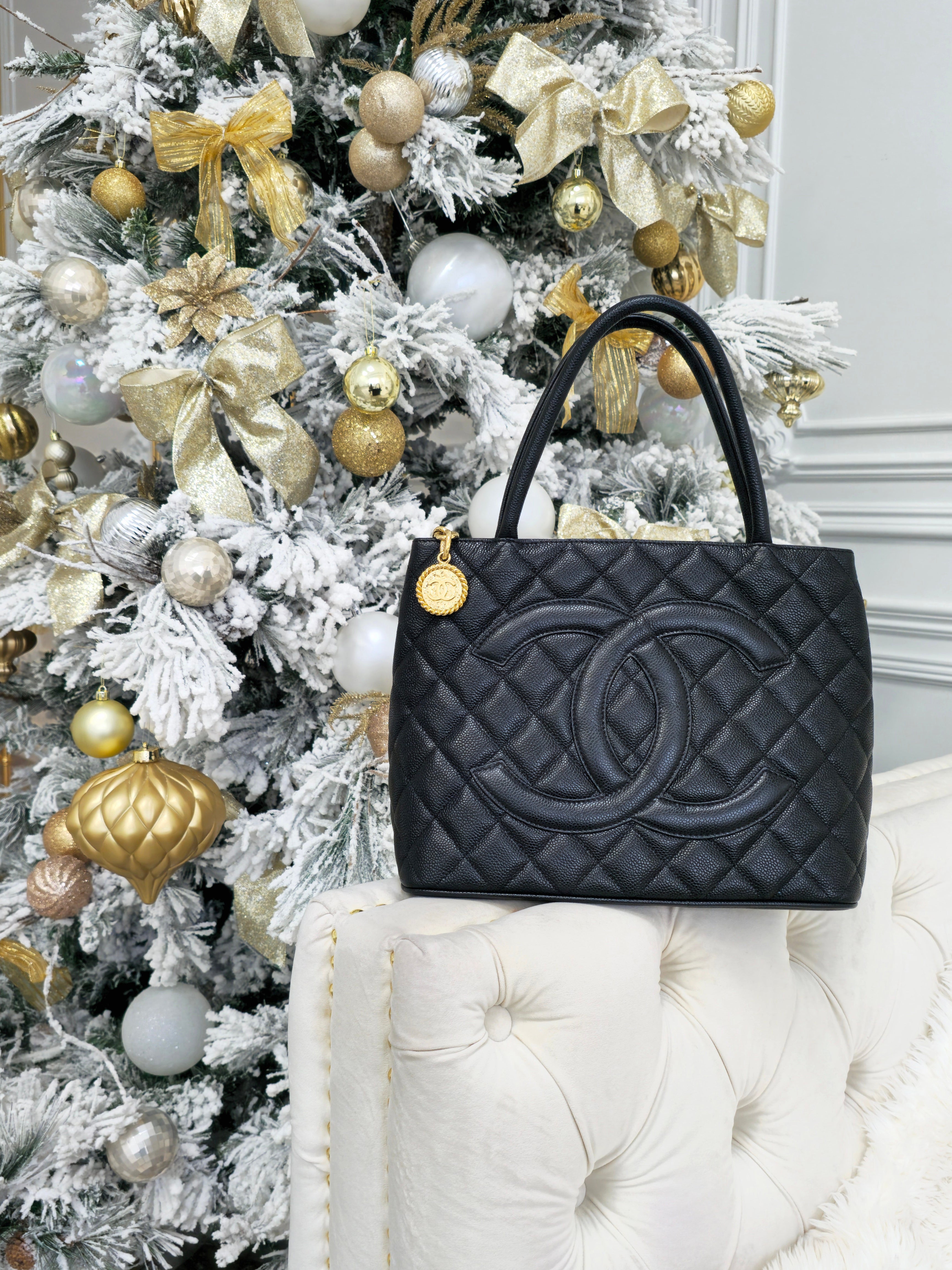 christmas season themed designer handbags showcasing pre-owned luxury chanel medallion tote bag in Forgotten Luxuries consignment store