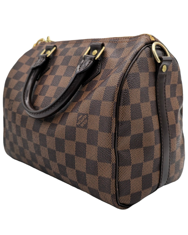 Louis Vuitton Damier Ebene Speedy Bandouliere 25 Louis VuittonDamier Ebene Speedy Bandouliere 25Louis Vuitton LV Damier Ebene Speedy Bandouliere 25 bag brown canvas leather with gold hardware side profileForgotten Luxuries Forgotten Luxuries