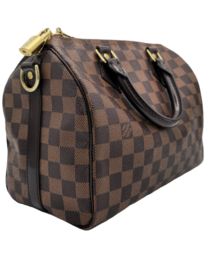 Louis Vuitton Damier Ebene Speedy Bandouliere 25 Louis VuittonDamier Ebene Speedy Bandouliere 25Louis Vuitton LV Damier Ebene Speedy Bandouliere 25 bag brown canvas leather with gold hardware side profileForgotten Luxuries Forgotten Luxuries