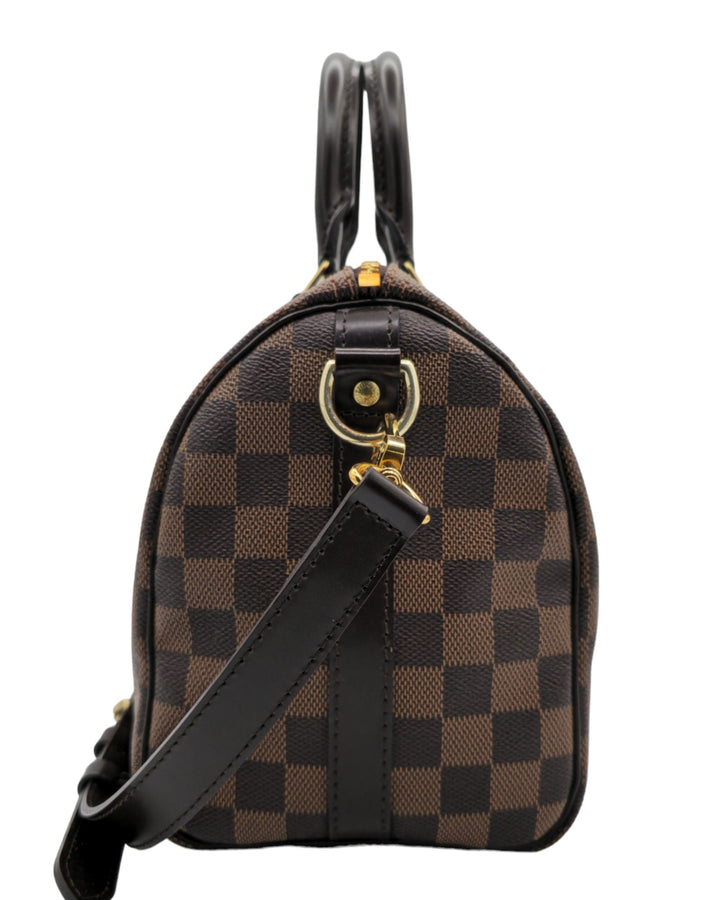 Louis Vuitton Damier Ebene Speedy Bandouliere 25 Louis VuittonDamier Ebene Speedy Bandouliere 25Louis Vuitton LV Damier Ebene Speedy Bandouliere 25 bag brown canvas leather with gold hardware side profileForgotten Luxuries Forgotten Luxuries